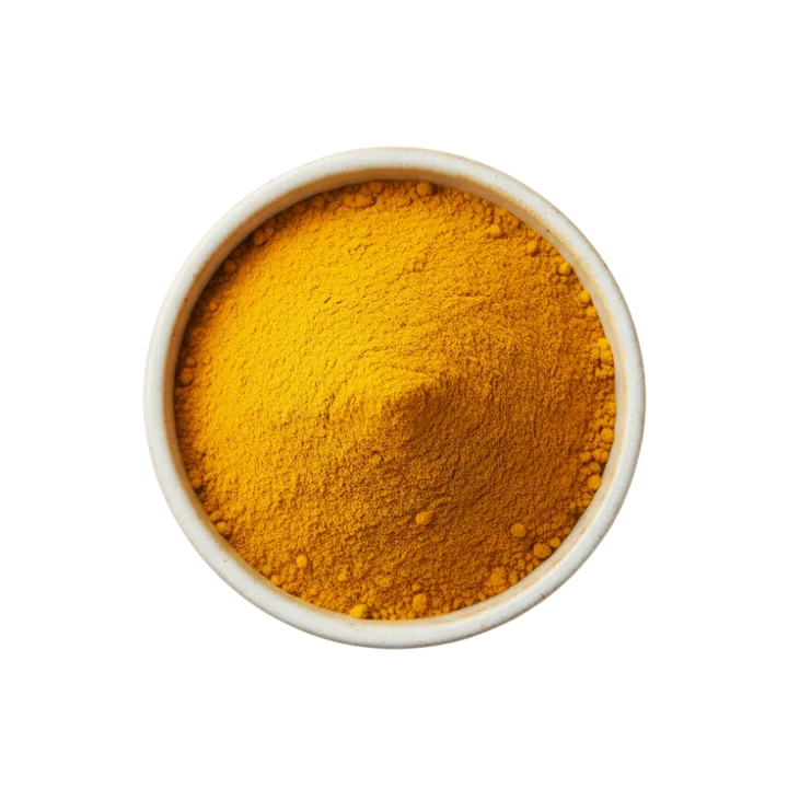 Turmeric powder in a white bowl on a light background